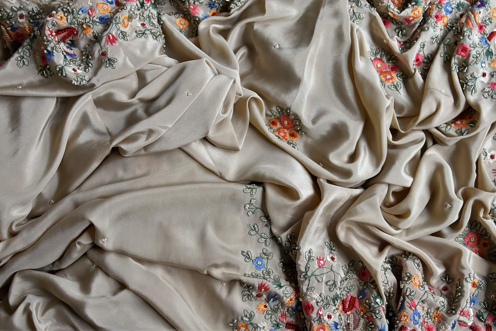 Buy beautiful beige floral crepe silk sari online in USA with hand embroidered border. Flaunt your sartorial choices on special occasions in stunning designer sarees, embroidered sarees, handloom sarees, Banarasi sarees, crepe sarees from Pure Elegance Indian fashion store in USA.-details