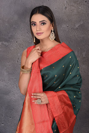 Buy beautiful dark green Gadhwal silk saree online in USA with red border and buta. Enrich your ethnic wardrobe with traditional Indian sarees, designer sarees. embroidered sarees, pure silk sarees, handwoven sarees, Kanchipuram sarees, Banarasi saris from Pure Elegance Indian saree store in USA.-closeup