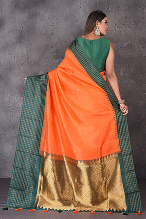 Buy gorgeous orange Gadhwal silk saree online in USA with green border and zari pallu. Enrich your ethnic wardrobe with traditional Indian sarees, designer sarees. embroidered sarees, pure silk sarees, handwoven sarees, Kanchipuram sarees, Banarasi saris from Pure Elegance Indian saree store in USA.-back