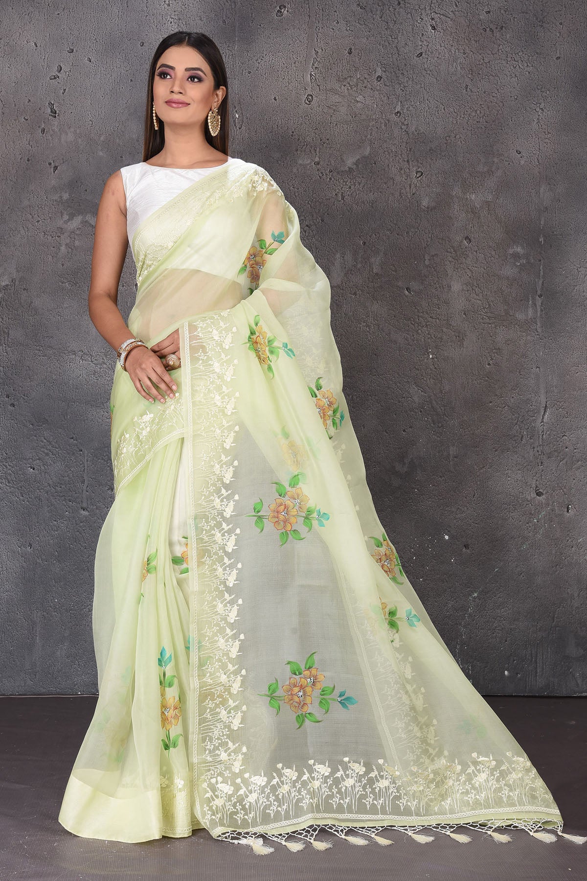 Shop stunning pastel green floral organza sari online in USA with embroidered border. Enrich your ethnic wardrobe with traditional Indian sarees, designer sarees. embroidered sarees, pure silk sarees, handwoven sarees, Kanchipuram sarees, Banarasi saris from Pure Elegance Indian saree store in USA.-full view