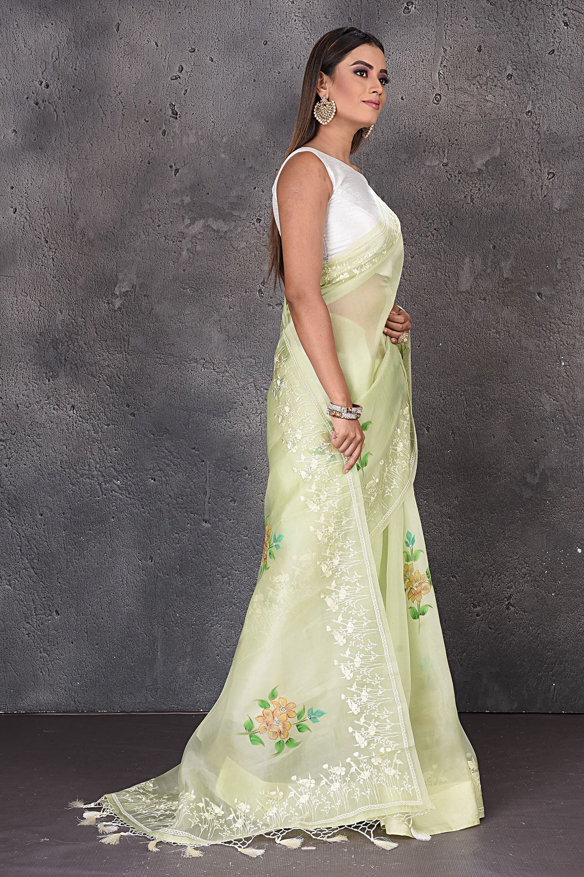 Shop stunning pastel green floral organza sari online in USA with embroidered border. Enrich your ethnic wardrobe with traditional Indian sarees, designer sarees. embroidered sarees, pure silk sarees, handwoven sarees, Kanchipuram sarees, Banarasi saris from Pure Elegance Indian saree store in USA.-side