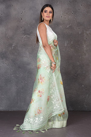 Buy stunning mint green floral organza sari online in USA with embroidered border. Enrich your ethnic wardrobe with traditional Indian sarees, designer sarees. embroidered sarees, pure silk sarees, handwoven sarees, Kanchipuram sarees, Banarasi saris from Pure Elegance Indian saree store in USA.-side