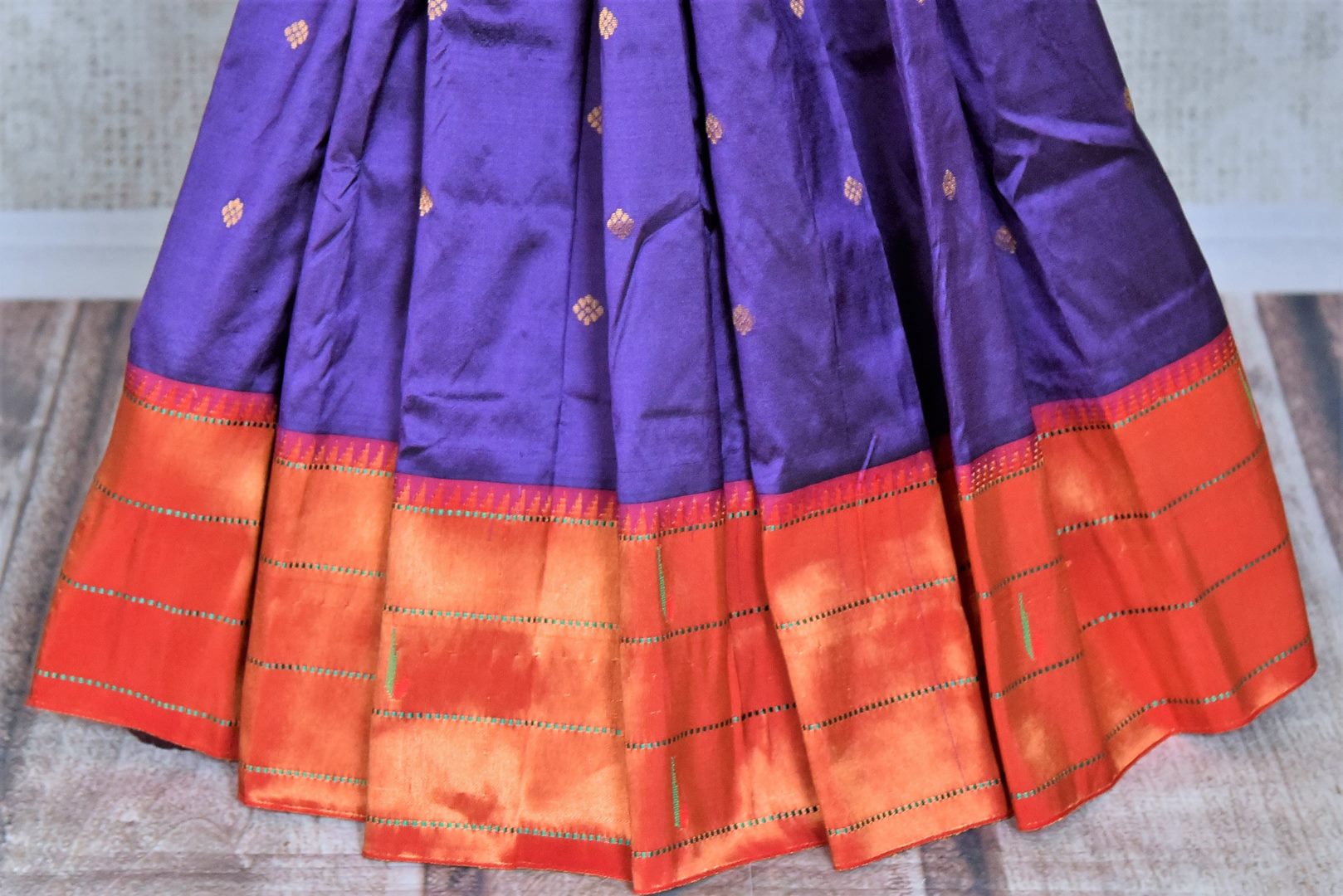 Buy stunning blue handloom silk Paithani saree online in USA with red zari border. Flaunt your sartorial choices on special occasions in stunning designer sarees, embroidered sarees, handloom sarees, Banarasi sarees, crepe sarees from Pure Elegance Indian fashion store in USA.-pleats