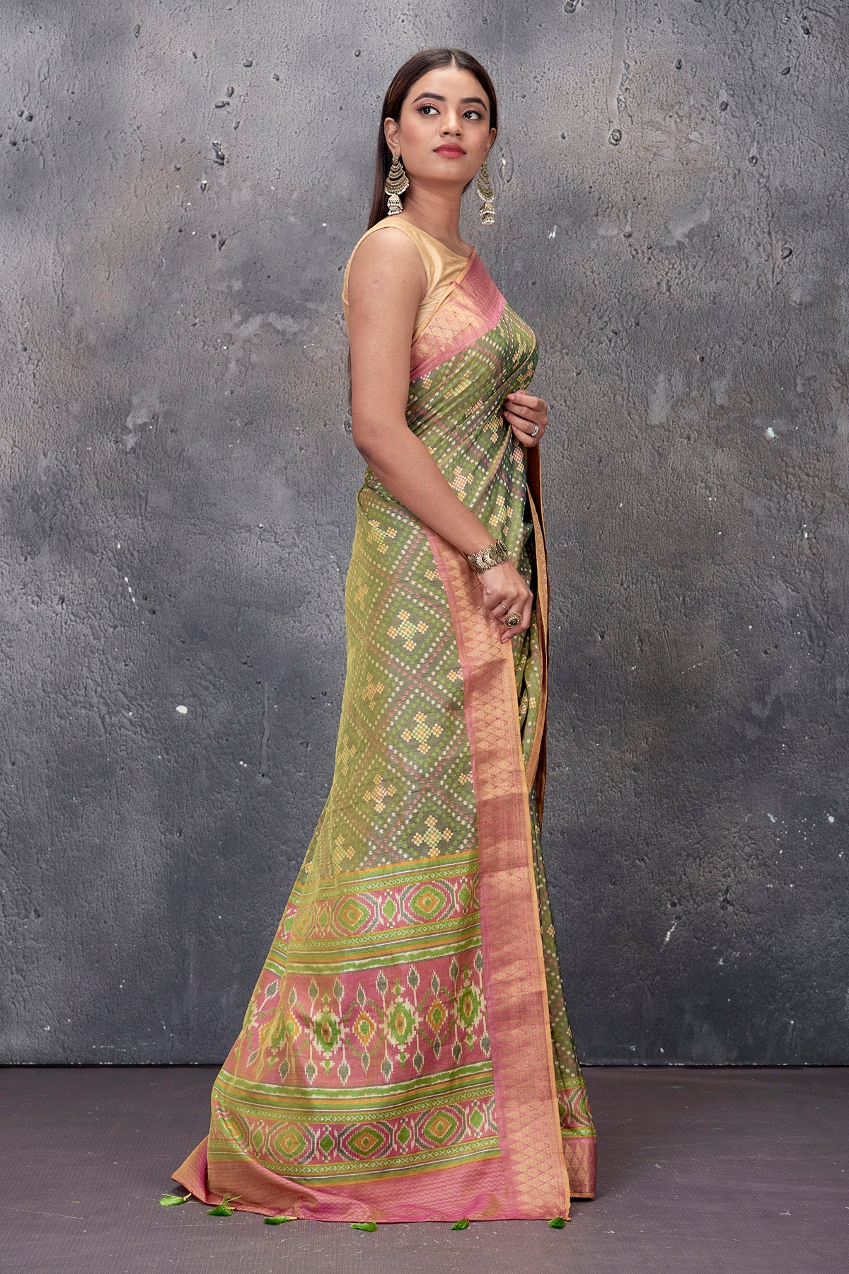 Buy stunning sage green fancy Patola saree online in USA with pink zari border. Keep your ethnic wardrobe up to date with latest designer saris, pure silk sarees, handwoven sarees, tussar silk sarees, embroidered saris from Pure Elegance Indian saree store in USA.-side