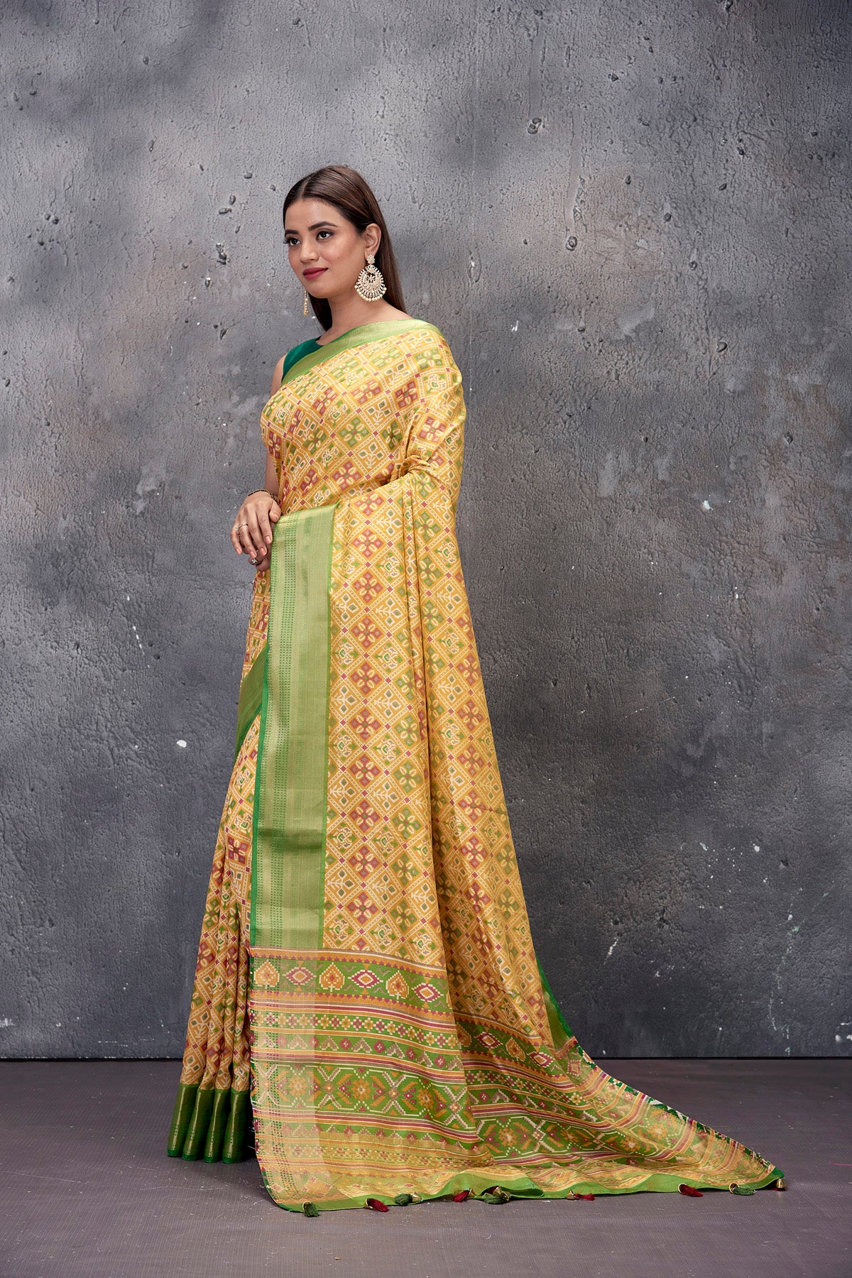 Buy gorgeous yellow printed fancy Patola sari online in USA with green zari border. Keep your ethnic wardrobe up to date with latest designer saris, pure silk sarees, handwoven sarees, tussar silk sarees, embroidered saris from Pure Elegance Indian saree store in USA.-full view