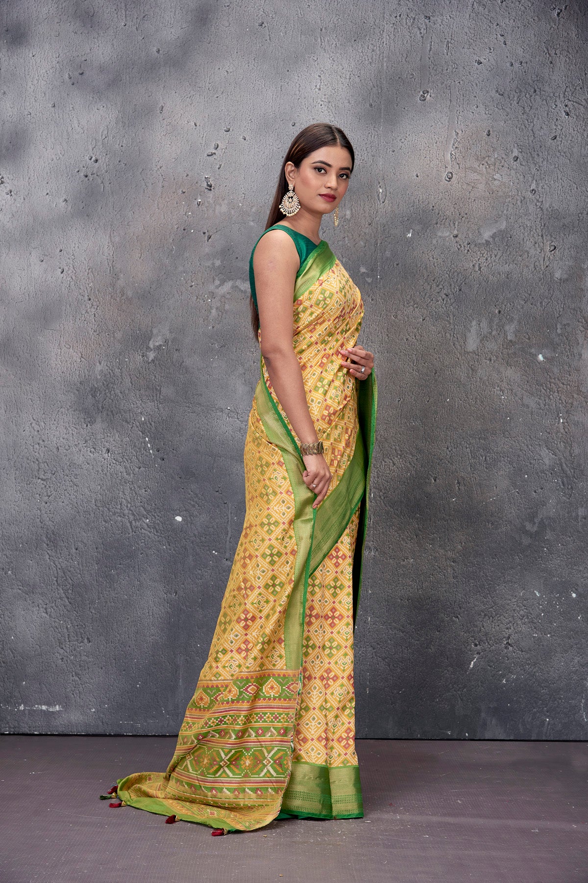 Buy gorgeous yellow printed fancy Patola sari online in USA with green zari border. Keep your ethnic wardrobe up to date with latest designer saris, pure silk sarees, handwoven sarees, tussar silk sarees, embroidered saris from Pure Elegance Indian saree store in USA.-side