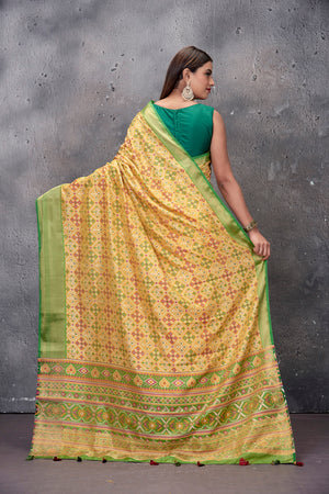 Buy gorgeous yellow printed fancy Patola sari online in USA with green zari border. Keep your ethnic wardrobe up to date with latest designer saris, pure silk sarees, handwoven sarees, tussar silk sarees, embroidered saris from Pure Elegance Indian saree store in USA.-back