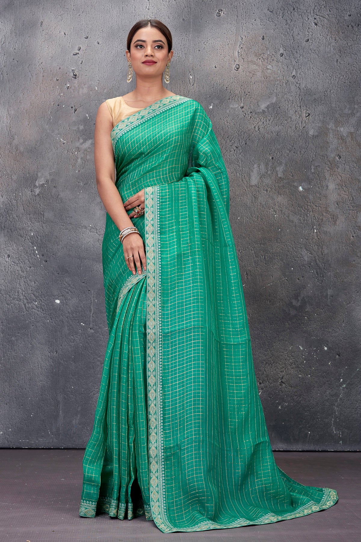 Shop stunning green designer saree online in USA with embroidered border and saree blouse. Keep your ethnic wardrobe up to date with latest designer saris, pure silk sarees, handwoven sarees, tussar silk sarees, embroidered saris from Pure Elegance Indian saree store in USA.-full view