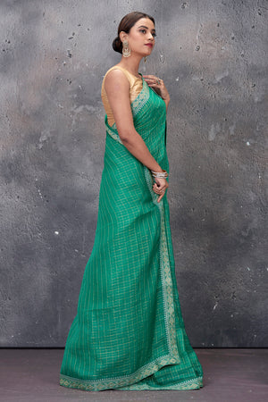 Shop stunning green designer saree online in USA with embroidered border and saree blouse. Keep your ethnic wardrobe up to date with latest designer saris, pure silk sarees, handwoven sarees, tussar silk sarees, embroidered saris from Pure Elegance Indian saree store in USA.-side