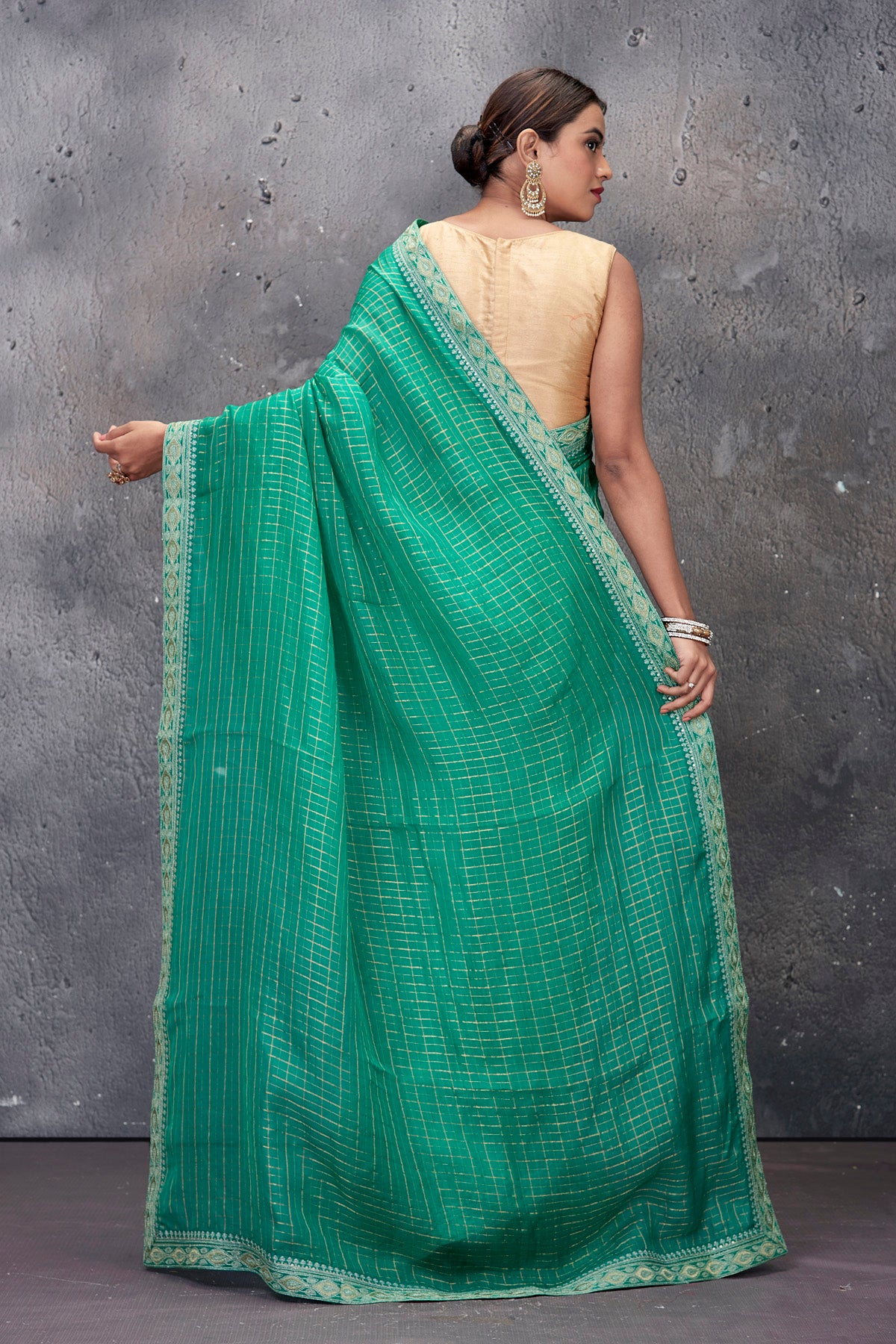 Shop stunning green designer saree online in USA with embroidered border and saree blouse. Keep your ethnic wardrobe up to date with latest designer saris, pure silk sarees, handwoven sarees, tussar silk sarees, embroidered saris from Pure Elegance Indian saree store in USA.-back