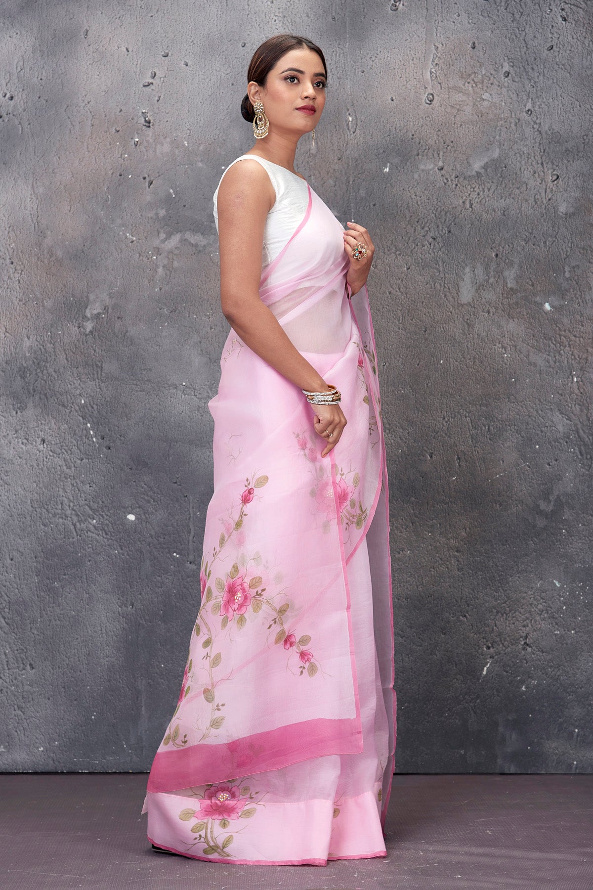Shop stunning powder pink hand painted organza saree online in USA. Keep your ethnic wardrobe up to date with latest designer saris, pure silk sarees, handwoven sarees, tussar silk sarees, embroidered saris from Pure Elegance Indian saree store in USA.-side
