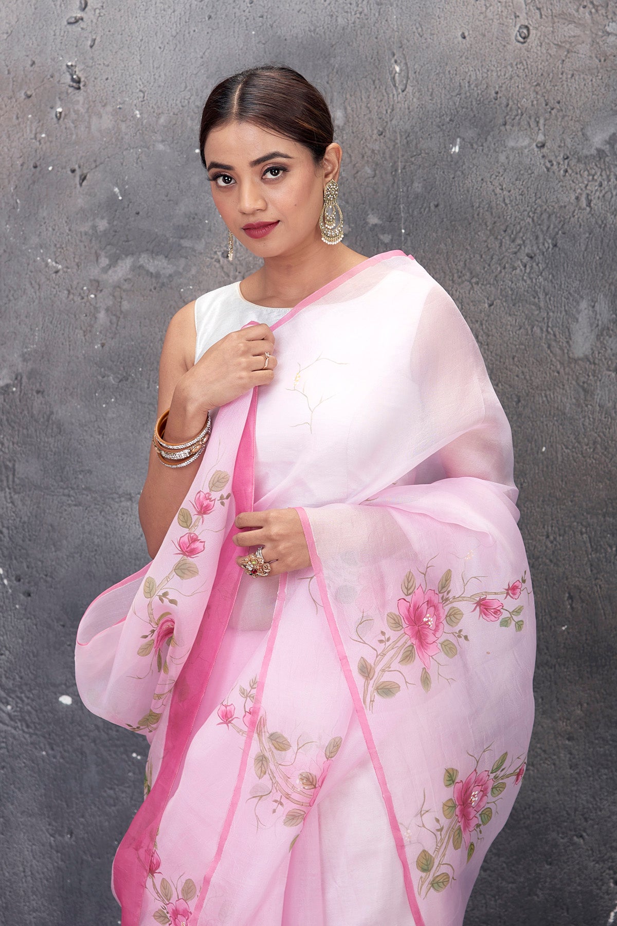 Shop stunning powder pink hand painted organza saree online in USA. Keep your ethnic wardrobe up to date with latest designer saris, pure silk sarees, handwoven sarees, tussar silk sarees, embroidered saris from Pure Elegance Indian saree store in USA.-closeup
