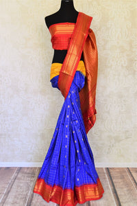 Buy beautiful royal blue Gadhwal silk saree online in USA with red zari border. Look elegant on special occasions in beautiful printed sarees, silk sarees, tussar sarees, handloom sarees, Kanchipuram sarees from Pure Elegance Indian saree store in USA.-full view