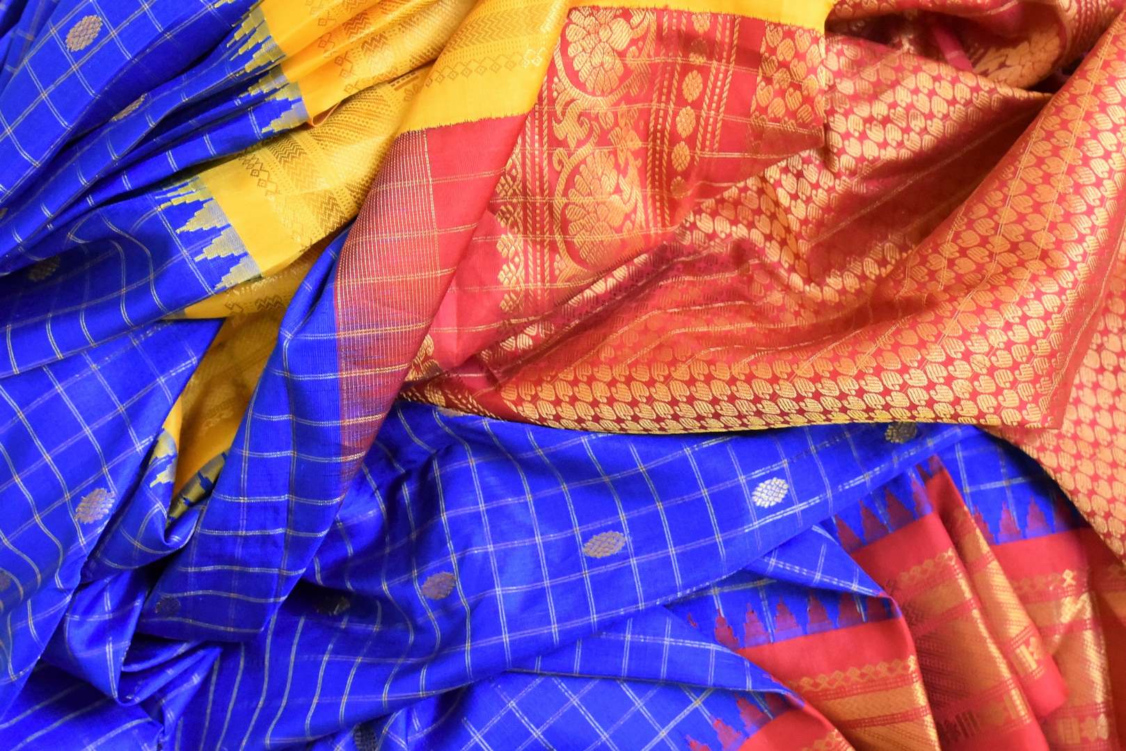 Buy beautiful royal blue Gadhwal silk saree online in USA with red zari border. Look elegant on special occasions in beautiful printed sarees, silk sarees, tussar sarees, handloom sarees, Kanchipuram sarees from Pure Elegance Indian saree store in USA.-details