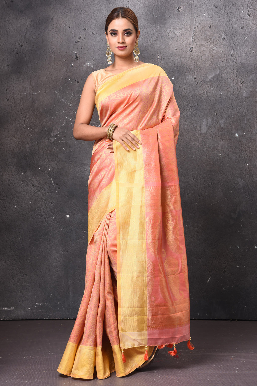 Buy gorgeous peach handloom Kanjivaram sari online in USA with yellow zari border. Keep your ethnic wardrobe up to date with latest designer sarees, pure silk sarees, handwoven sarees, tussar silk sarees, embroidered sarees, chiffon saris from Pure Elegance Indian saree store in USA.-full view