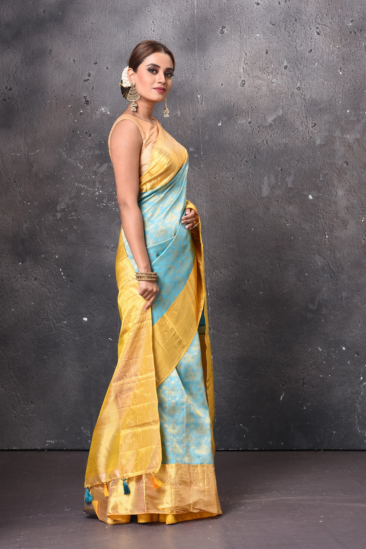 Buy stunning pastel blue handloom Kanjivaram sari online in USA with yellow zari border. Keep your ethnic wardrobe up to date with latest designer sarees, pure silk sarees, handwoven sarees, tussar silk sarees, embroidered sarees, chiffon saris from Pure Elegance Indian saree store in USA.-side