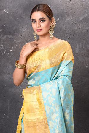 Buy stunning pastel blue handloom Kanjivaram sari online in USA with yellow zari border. Keep your ethnic wardrobe up to date with latest designer sarees, pure silk sarees, handwoven sarees, tussar silk sarees, embroidered sarees, chiffon saris from Pure Elegance Indian saree store in USA.-closeup