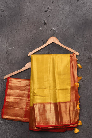 Shop beautiful yellow handloom Kanjivaram sari online in USA with red zari border. Keep your ethnic wardrobe up to date with latest designer sarees, pure silk sarees, handwoven sarees, tussar silk sarees, embroidered sarees, chiffon saris from Pure Elegance Indian saree store in USA.-blouse