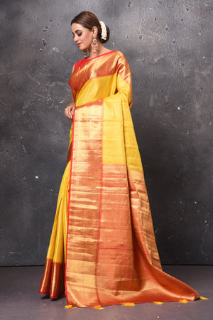 Shop beautiful yellow handloom Kanjivaram sari online in USA with red zari border. Keep your ethnic wardrobe up to date with latest designer sarees, pure silk sarees, handwoven sarees, tussar silk sarees, embroidered sarees, chiffon saris from Pure Elegance Indian saree store in USA.-pallu