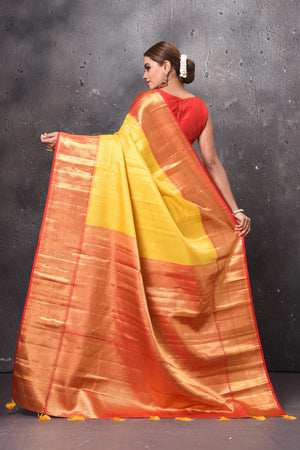 Shop beautiful yellow handloom Kanjivaram sari online in USA with red zari border. Keep your ethnic wardrobe up to date with latest designer sarees, pure silk sarees, handwoven sarees, tussar silk sarees, embroidered sarees, chiffon saris from Pure Elegance Indian saree store in USA.-back