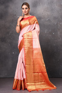 Buy gorgeous light pink handloom Kanjivaram sari online in USA with red zari border. Keep your ethnic wardrobe up to date with latest designer sarees, pure silk sarees, handwoven sarees, tussar silk sarees, embroidered sarees, chiffon saris from Pure Elegance Indian saree store in USA.-full view