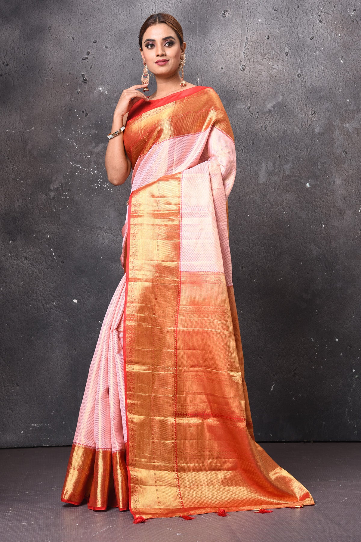 Buy gorgeous light pink handloom Kanjivaram sari online in USA with red zari border. Keep your ethnic wardrobe up to date with latest designer sarees, pure silk sarees, handwoven sarees, tussar silk sarees, embroidered sarees, chiffon saris from Pure Elegance Indian saree store in USA.-pallu
