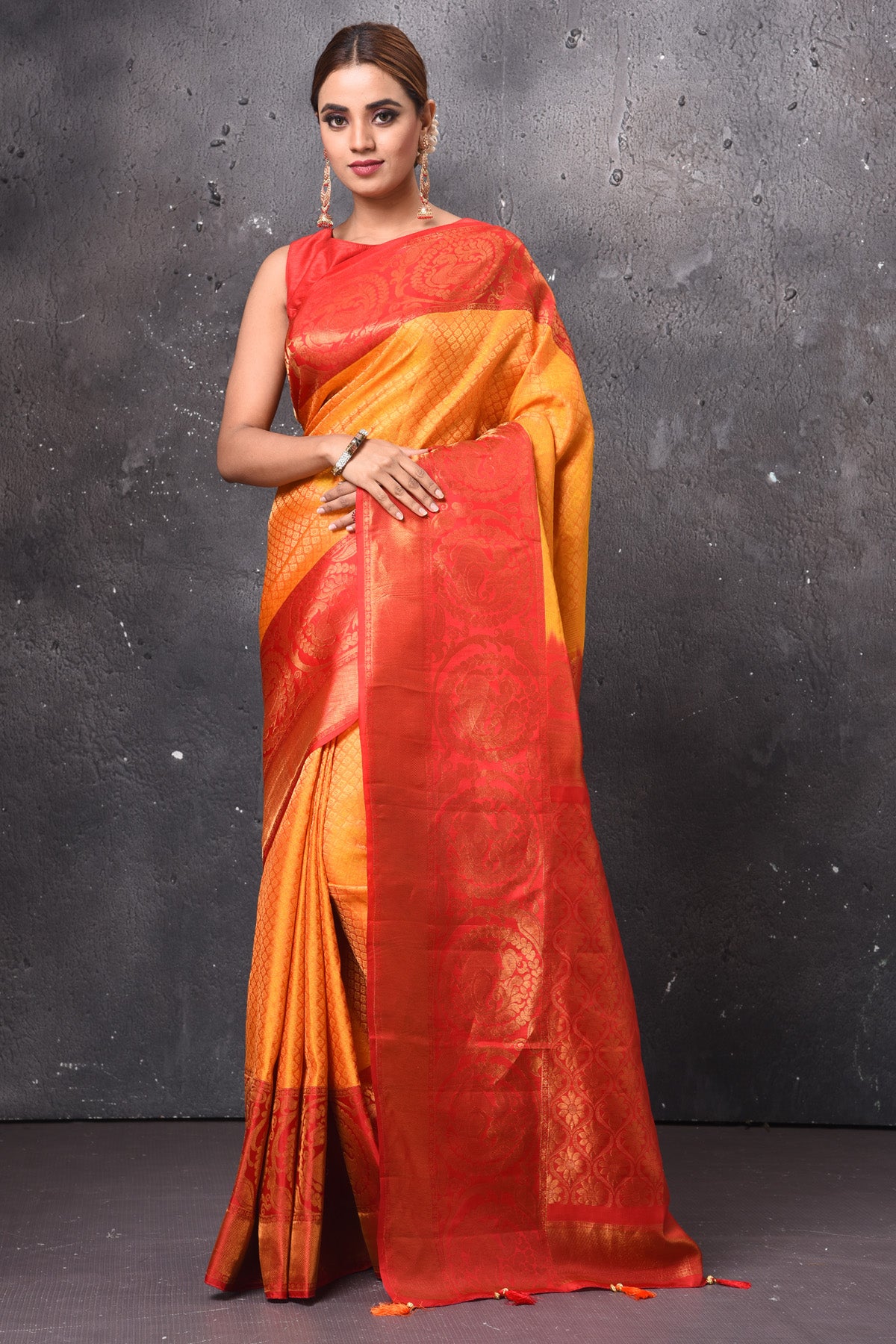 Buy stunning orange Gadwal check sari online in USA with red zari border. Keep your ethnic wardrobe up to date with latest designer sarees, pure silk sarees, handwoven sarees, tussar silk sarees, embroidered sarees, Banarasi saris from Pure Elegance Indian saree store in USA.-full view