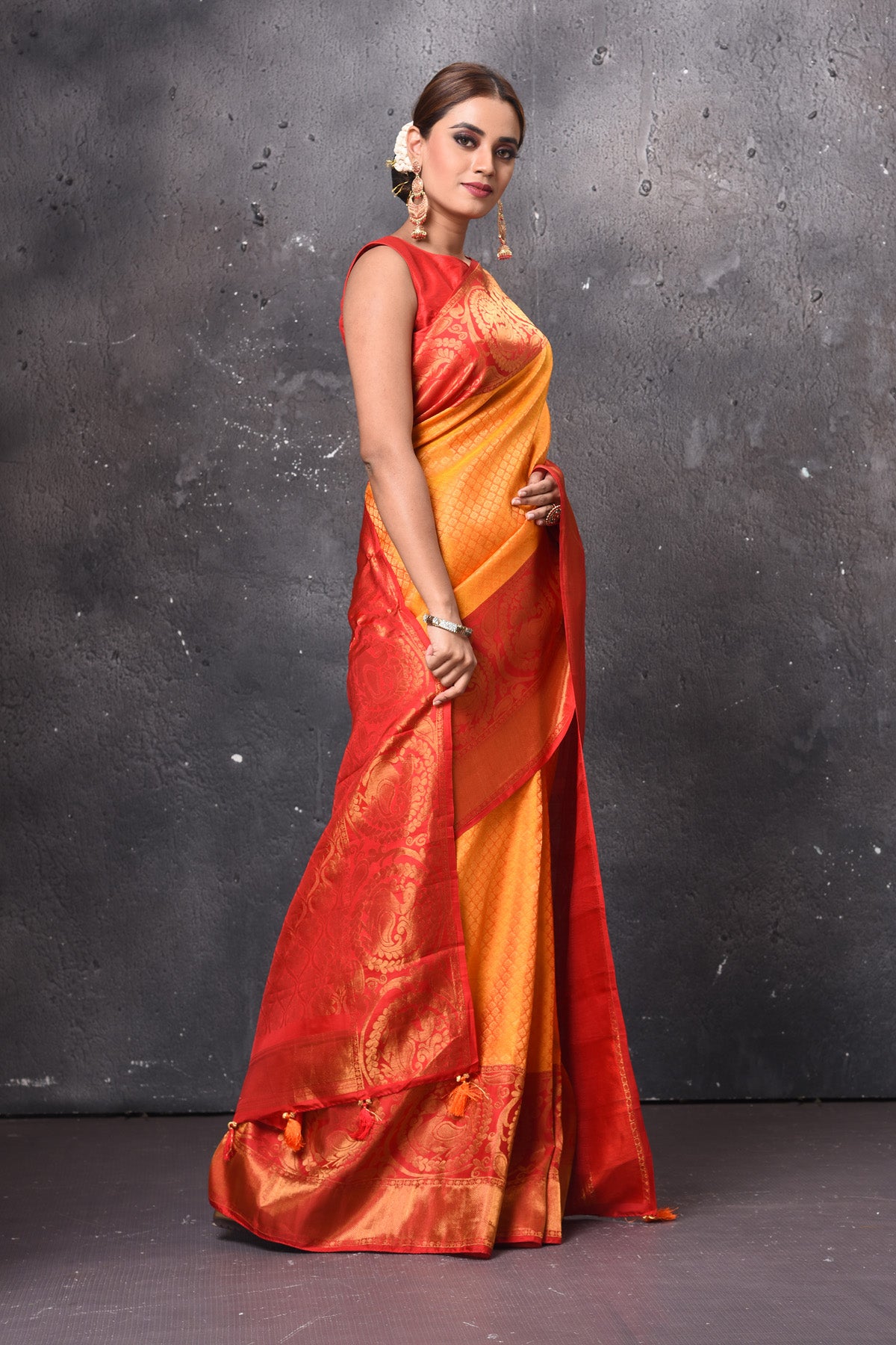 Buy stunning orange Gadwal check sari online in USA with red zari border. Keep your ethnic wardrobe up to date with latest designer sarees, pure silk sarees, handwoven sarees, tussar silk sarees, embroidered sarees, Banarasi saris from Pure Elegance Indian saree store in USA.-side