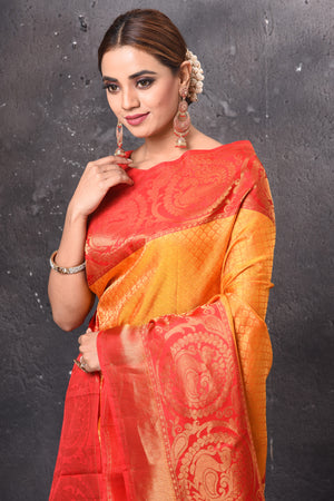 Buy stunning orange Gadwal check sari online in USA with red zari border. Keep your ethnic wardrobe up to date with latest designer sarees, pure silk sarees, handwoven sarees, tussar silk sarees, embroidered sarees, Banarasi saris from Pure Elegance Indian saree store in USA.-closeup