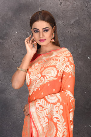 Buy stunning orange fancy georgette saree online in USA with zari work. Keep your ethnic wardrobe updated with latest designer sarees, pure silk sarees, handwoven sarees, tussar silk sarees, embroidered sarees from Pure Elegance Indian saree store in USA.-closeup