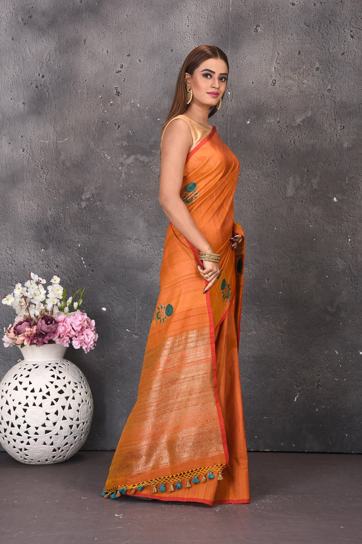 Buy stunning orange tussar silk saree online in USA with antique zari pallu. Keep your ethnic wardrobe updated with latest designer sarees, pure silk sarees, handwoven sarees, tussar silk sarees, embroidered sarees from Pure Elegance Indian saree store in USA.-side