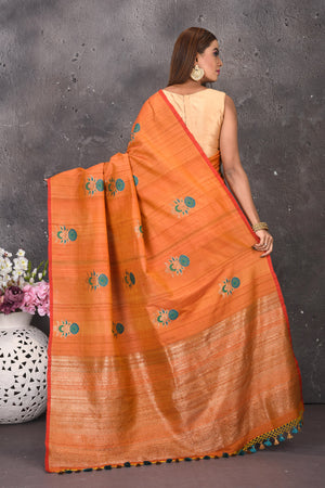 Buy stunning orange tussar silk saree online in USA with antique zari pallu. Keep your ethnic wardrobe updated with latest designer sarees, pure silk sarees, handwoven sarees, tussar silk sarees, embroidered sarees from Pure Elegance Indian saree store in USA.-back