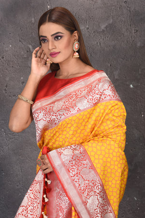 Shop beautiful yellow fancy Katan silk saree online in USA with red zari border. Keep your ethnic wardrobe updated with latest designer sarees, pure silk sarees, handwoven sarees, tussar silk sarees, embroidered sarees from Pure Elegance Indian saree store in USA.-closeup