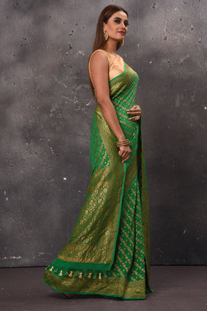 Buy stunning green georgette saree online in USA with overall zari work. Keep your ethnic wardrobe up to date with latest designer sarees, pure silk sarees, handwoven sarees, tussar silk sarees, embroidered sarees, chiffon saris from Pure Elegance Indian saree store in USA.-side