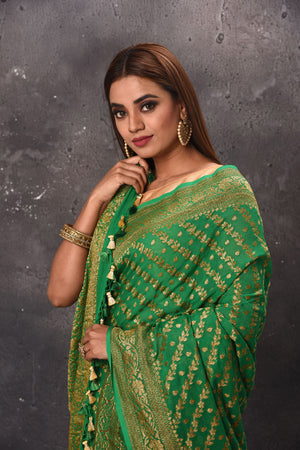 Buy stunning green georgette saree online in USA with overall zari work. Keep your ethnic wardrobe up to date with latest designer sarees, pure silk sarees, handwoven sarees, tussar silk sarees, embroidered sarees, chiffon saris from Pure Elegance Indian saree store in USA.-closeup