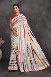 Buy beautiful off-white multicolor stripes applique linen sari online in USA. Keep your ethnic wardrobe up to date with latest designer sarees, pure silk sarees, handwoven sarees, tussar silk sarees, embroidered sarees from Pure Elegance Indian saree store in USA.-full view