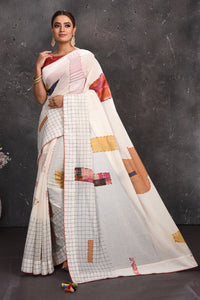 Buy beautiful off-white applique linen sari online in USA with check border. Keep your ethnic wardrobe up to date with latest designer sarees, pure silk sarees, handwoven sarees, tussar silk sarees, embroidered sarees from Pure Elegance Indian saree store in USA.-full view