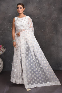 Buy beautiful white organza saree online in USA with silver applique work. Keep your ethnic wardrobe up to date with latest designer sarees, pure silk sarees, handwoven sarees, tussar silk sarees, embroidered sarees from Pure Elegance Indian saree store in USA.-full view