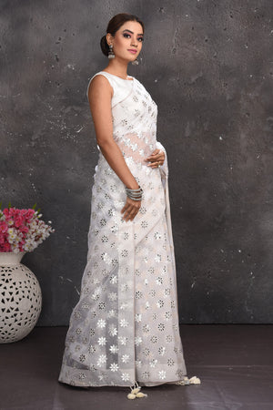 Buy beautiful white organza saree online in USA with silver applique work. Keep your ethnic wardrobe up to date with latest designer sarees, pure silk sarees, handwoven sarees, tussar silk sarees, embroidered sarees from Pure Elegance Indian saree store in USA.-side