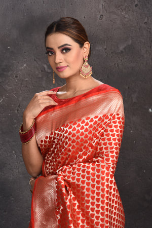 Shop stunning red Banarasi silk saree online in USA with zari border. Keep your ethnic wardrobe up to date with latest designer sarees, pure silk sarees, handwoven sarees, tussar silk sarees, embroidered sarees from Pure Elegance Indian saree store in USA.-closeup