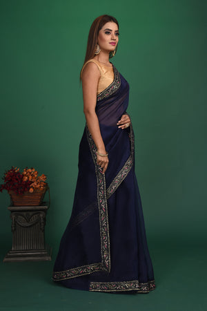 Buy stunning navy blue organza sari online in USA with heavy embroidery blouse. Keep your ethnic wardrobe up to date with latest designer sarees, pure silk sarees, handwoven sarees, tussar silk sarees, embroidered sarees, organza saris from Pure Elegance Indian saree store in USA.-side