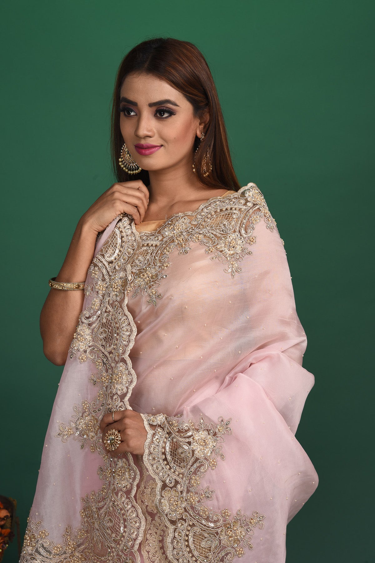 Shop beautiful powder pink embroidered organza sari online in USA. Keep your ethnic wardrobe up to date with latest designer sarees, pure silk sarees, handwoven sarees, tussar silk sarees, embroidered sarees, organza saris from Pure Elegance Indian saree store in USA.-closeup