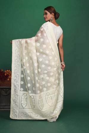 Shop stunning off-white Lucknowi georgette sari online in USA. Keep your ethnic wardrobe up to date with latest designer sarees, pure silk sarees, handwoven sarees, tussar silk sarees, embroidered sarees, organza saris from Pure Elegance Indian saree store in USA.-back