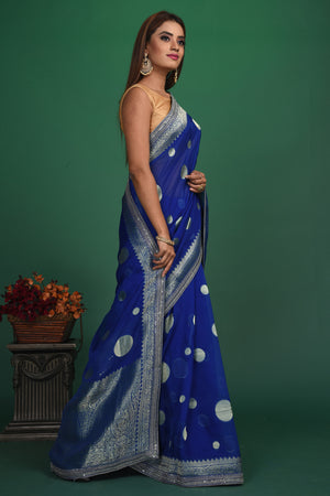 Buy beautiful royal blue georgette Banarasi sari online in USA with silver zari border. Keep your ethnic wardrobe up to date with latest designer sarees, pure silk sarees, handwoven sarees, tussar silk sarees, embroidered sarees, organza saris from Pure Elegance Indian saree store in USA.-side
