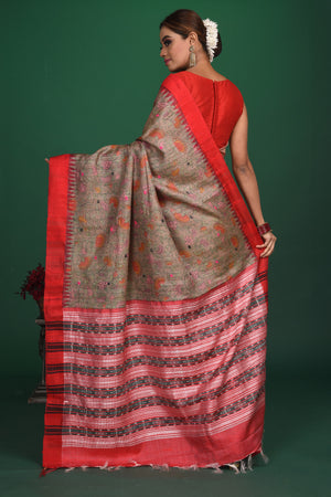 Shop elegant grey vidharba tussar printed saree online in USA with red border. Slay ethnic style on special occasions with beautiful designer sarees, handwoven sarees, embroidered sarees, party wear sarees, Bollywood sarees from Pure Elegance Indian saree store in USA.-back