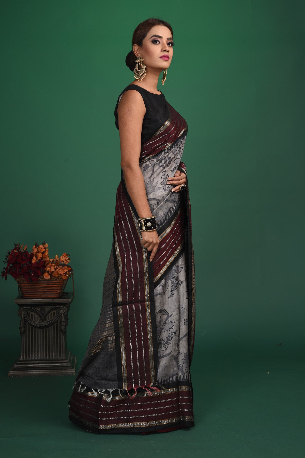 Buy this exquisite dark grey tussar saree with multicolor vidharbha and zari border online in USA which is handcrafted from fine silk tussar fabric, this tie and dye saree brings out the nature of flow. This tussar saree with elegant Vidharbha border is making everyone swoon over it. Make it yours and flaunt a handwoven marvel with minimal jewellery for a casual day outfit. Add this pure tussar saree to your collection from Pure Elegance Indian fashion store in USA.-Side view.