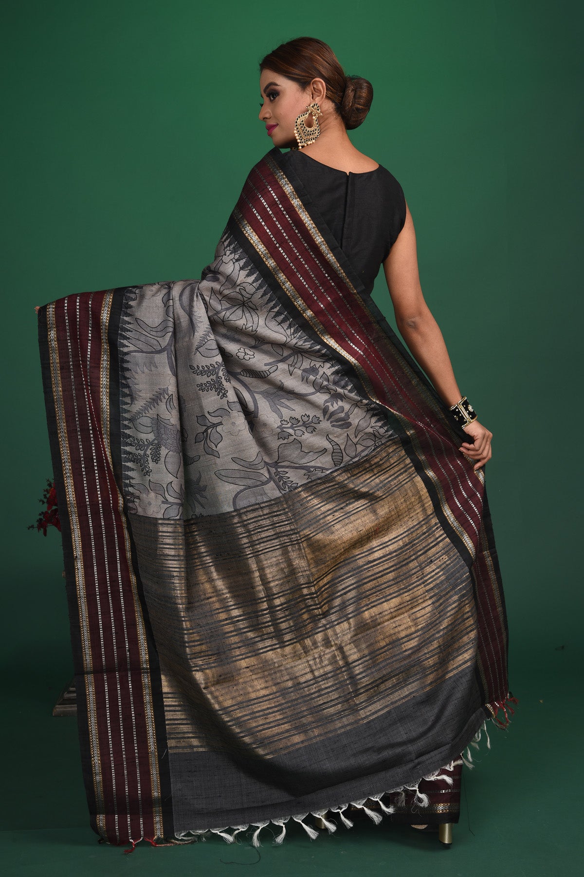 Buy this exquisite dark grey tussar saree with multicolor vidharbha and zari border online in USA which is handcrafted from fine silk tussar fabric, this tie and dye saree brings out the nature of flow. This tussar saree with elegant Vidharbha border is making everyone swoon over it. Make it yours and flaunt a handwoven marvel with minimal jewellery for a casual day outfit. Add this pure tussar saree to your collection from Pure Elegance Indian fashion store in USA.-Back view with open pallu.