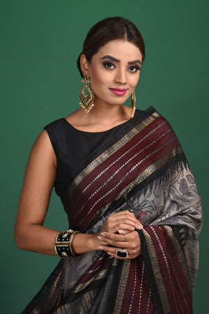 Buy this exquisite dark grey tussar saree with multicolor vidharbha and zari border online in USA which is handcrafted from fine silk tussar fabric, this tie and dye saree brings out the nature of flow. This tussar saree with elegant Vidharbha border is making everyone swoon over it. Make it yours and flaunt a handwoven marvel with minimal jewellery for a casual day outfit. Add this pure tussar saree to your collection from Pure Elegance Indian fashion store in USA.-Close up.