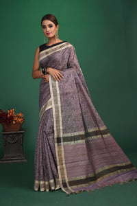 Shop this exquisite lavender purple tussar saree with purple vidharbha border online in USA which is handcrafted from fine silk tussar fabric, this tie and dye saree brings out the nature of flow. This tussar saree with elegant purple Vidharbha border is making everyone swoon over it. Make it yours and flaunt a handwoven marvel with minimal jewellery for a casual day outfit. Add this pure tussar saree to your collection from Pure Elegance Indian fashion store in USA.-Full view with open pallu.