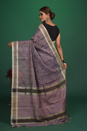 Shop this exquisite lavender purple tussar saree with purple vidharbha border online in USA which is handcrafted from fine silk tussar fabric, this tie and dye saree brings out the nature of flow. This tussar saree with elegant purple Vidharbha border is making everyone swoon over it. Make it yours and flaunt a handwoven marvel with minimal jewellery for a casual day outfit. Add this pure tussar saree to your collection from Pure Elegance Indian fashion store in USA.-Back view with open pallu.